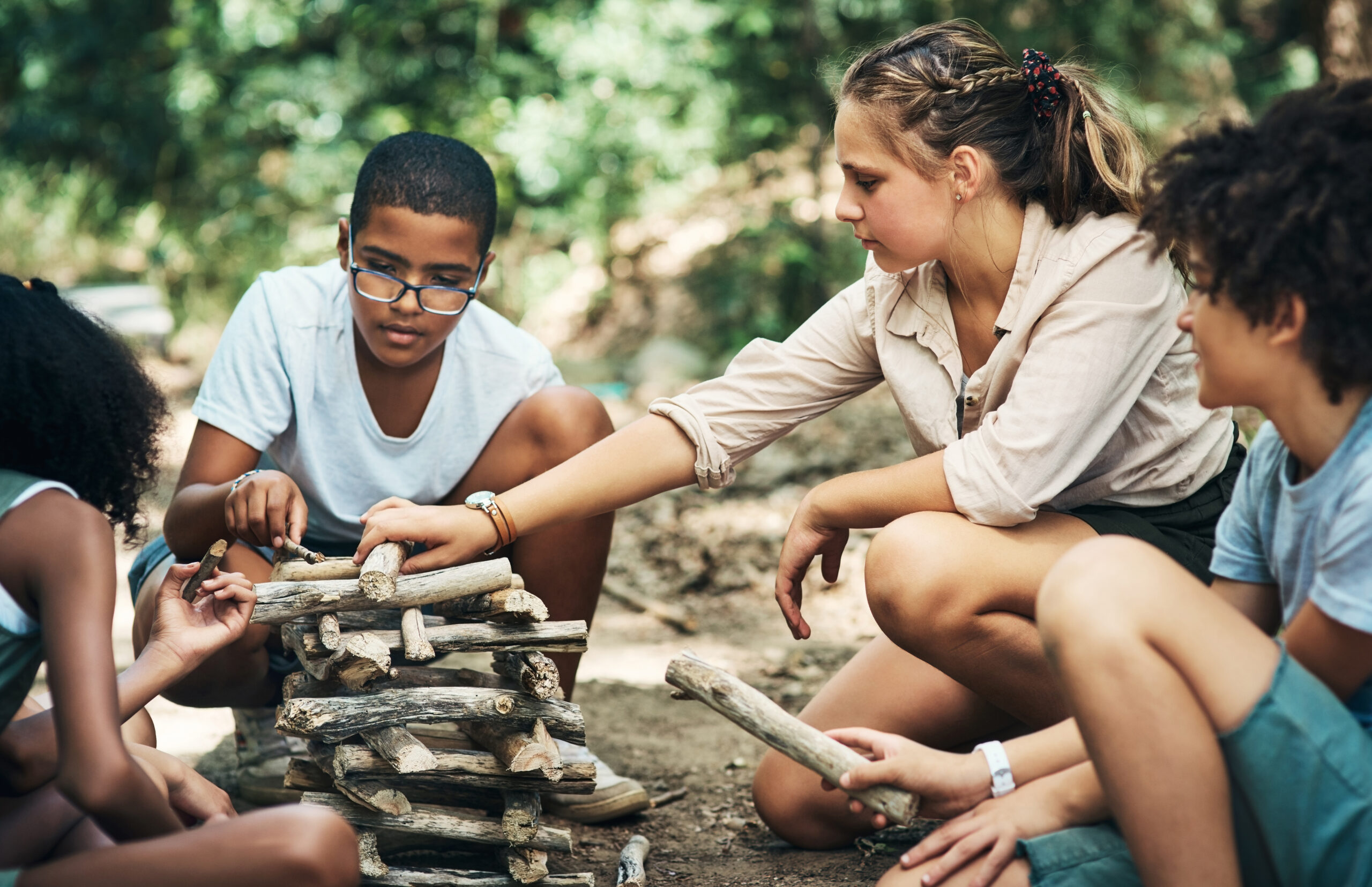 Youth working together at an outdoor camp